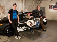 Blink 182  The band posed with a sports car.